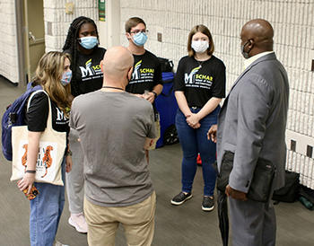 Mason President Gregory Washington, right, meets with Democracy Lab leaders.