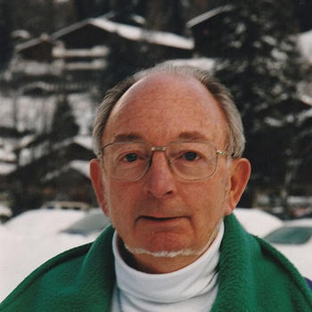 A man in eyeglasses and with a chin beard gazes at the camera.